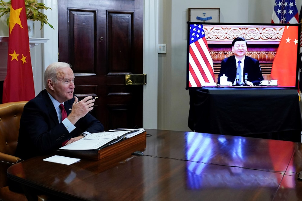 US President Joe Biden meets virtually with Chinese President Xi Jinping from the Roosevelt Room of the White House in Washington, on Nov. 15, 2021. (AP Photo/Susan Walsh, File)