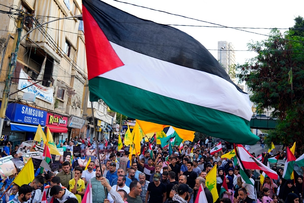 Hezbollah supporters wave the party's flag, as well as Palestinian and Lebanon flags during a protest in solidarity with the Palestinian people in Gaza, in Beirut, Lebanon, Friday, October 27, 2023 (AP)