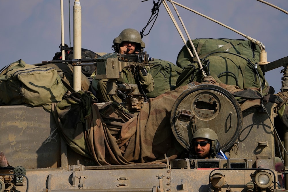 Israeli soldiers move towards the Gaza Strip border in an armored vehicle, Wednesday, Nov.1, 2023 (AP)
