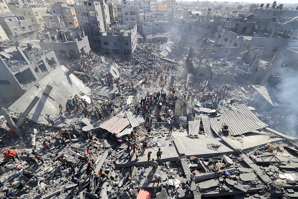 People search for survivors and for bodies of victims through the rubble of buildings destroyed during Israeli airstrikes, in Khan Yunis in the southern Gaza Strip, October 26, 2023, amid the Israeli genocide in Gaza. (AFP)