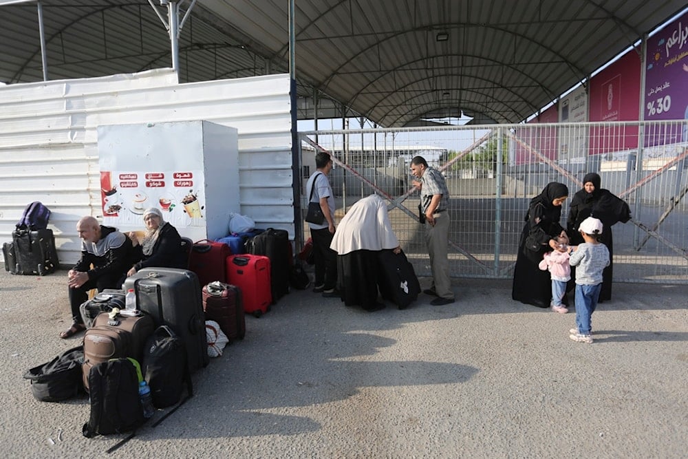 Palestinains wait at The border crossing bwteen Gaza Strip and Egypt in Rafah, Wednesday, Nov. 1, 2023 (AP)