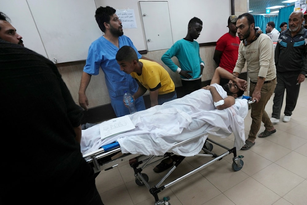 Palestinians wounded in the Israeli bombardment of the Gaza Strip are brought to a treatment room of al Aqsa Hospital on Deir al Balah, Gaza Strip, Friday, Nov. 10, 2023 (AP Photo/Adel Hana)