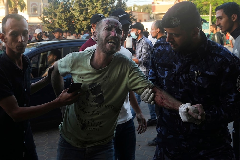 Palestinians wounded in the Israeli bombardment of the Gaza Strip are brought to a treatment room of al Aqsa Hospital on Deir al Balah, Monday, Nov. 6, 2023 (AP Photo/Adel Hana)