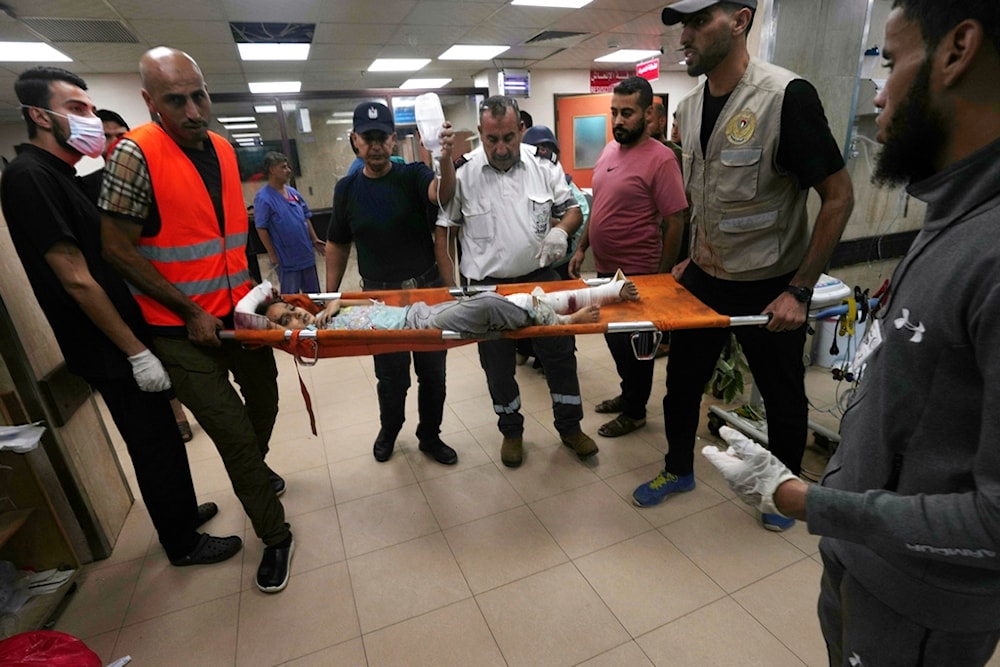 Palestinian child wounded in the Israeli bombardment of the Gaza Strip is brought to a treatment room of al Aqsa Hospital in Deir al Balah on Deir al Balah, Sunday, Nov. 5, 2023 (AP Photo/Adel Hana)
