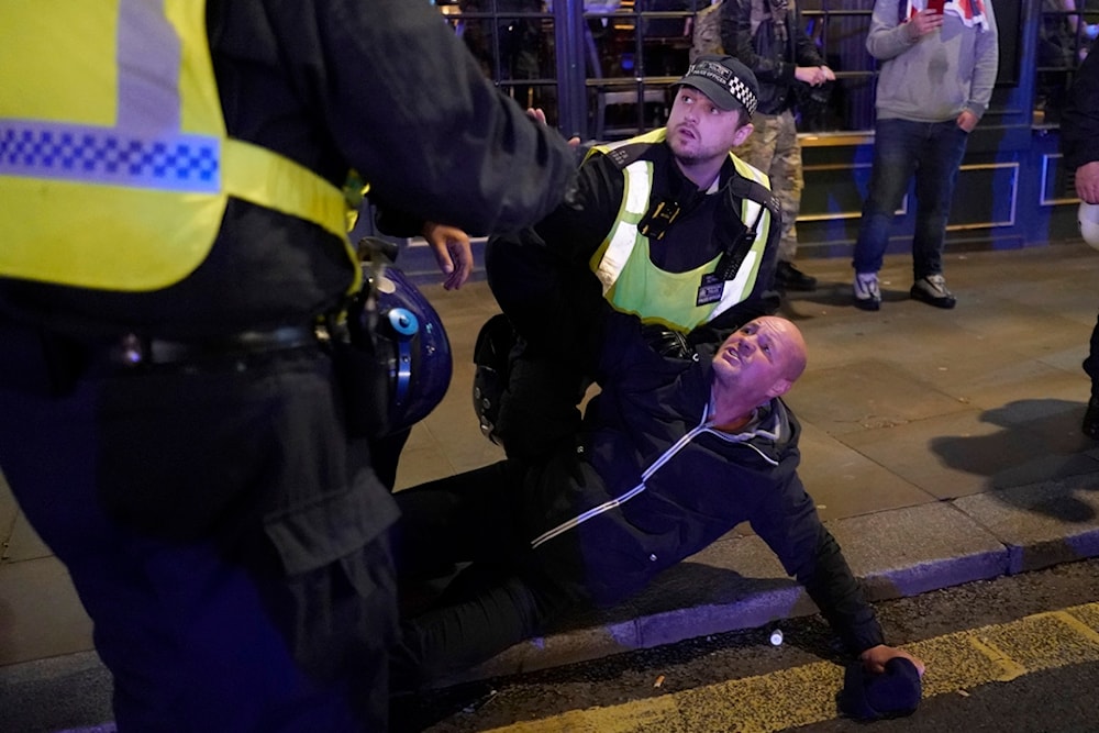 A far-right counter-protester is arrested by police in London, Saturday, Nov. 11, 2023, after a pro-Palestinian protest march from Hyde Park to the US embassy in Vauxhall (AP Photo/Alberto Pezzali)