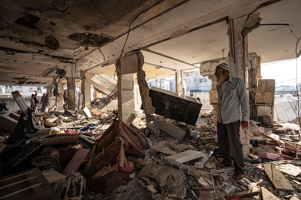 Palestinians look at the destruction after Israeli strikes on the Gaza Strip in Khan Younis, Friday, Now. 3, 2023 (AP)