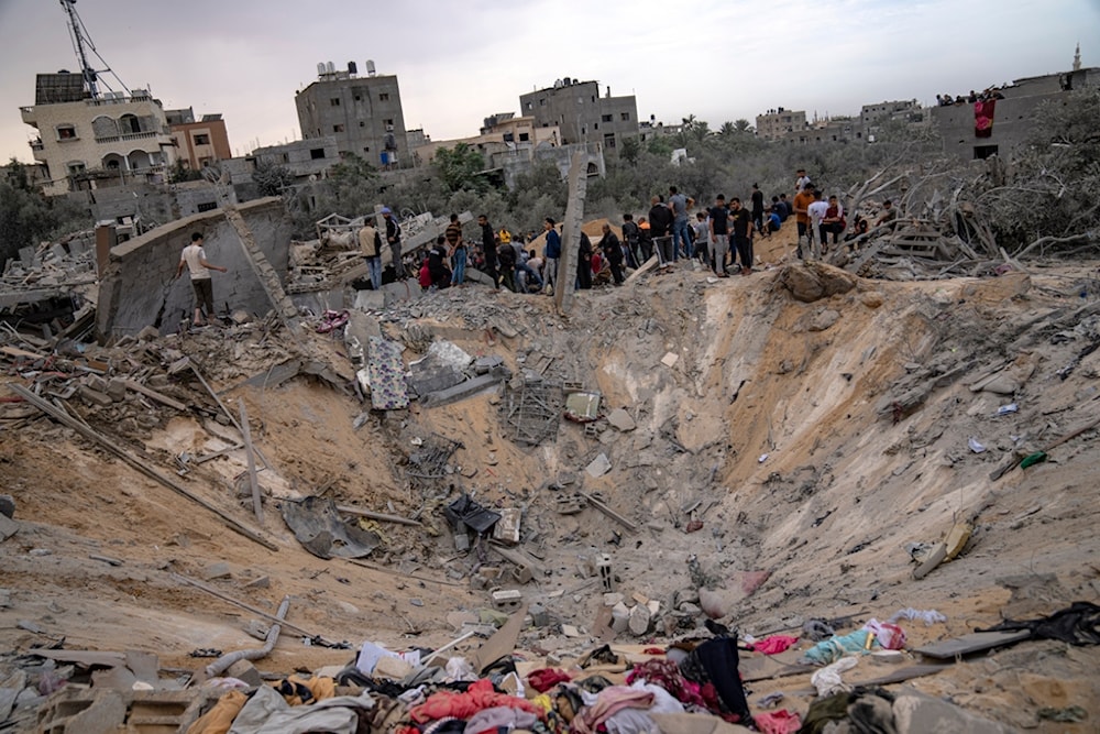 Palestinians look for survivors following an Israeli airstrike in Khan Younis, southern Gaza Strip, Sunday, Nov. 12, 2023 ( AP Photo/Fatima Shbair)