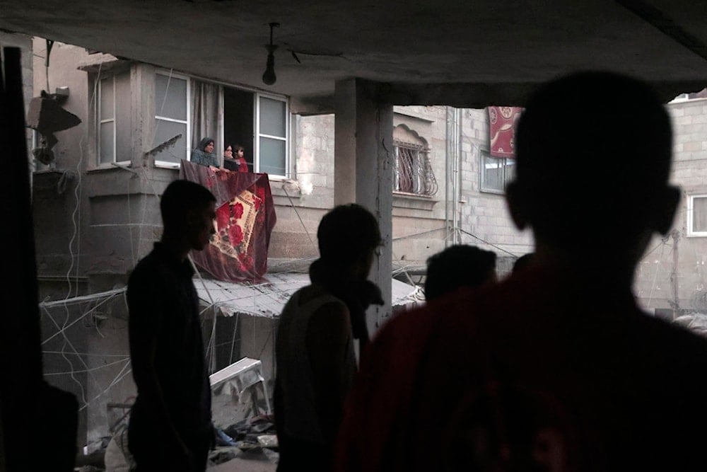 Palestinians look for survivors under the rubble of a destroyed house following an Israeli airstrike in Khan Younis refugee camp, southern Gaza Strip, Monday, Nov. 13, 2023. (AP Photo/Mohammed Dahman)