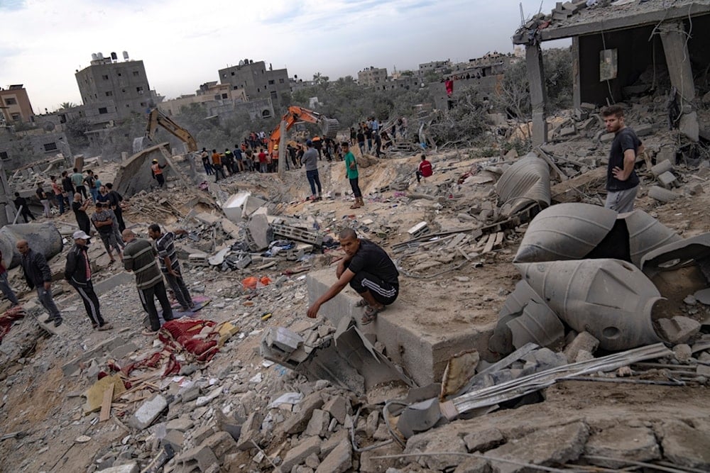 Palestinians look for survivors following an Israeli airstrike in Khan Younis, southern Gaza Strip, Sunday, Nov. 12, 2023 ( AP Photo/Fatima Shbair)