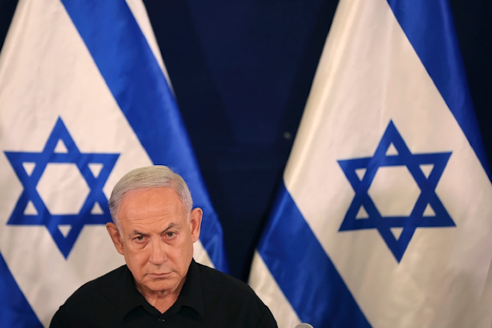Israeli Prime Minister Benjamin Netanyahu attends a press conference with Security Minister Yoav Gallant and Cabinet Minister Benny Gantz in the Kirya military base in 'Tel Aviv', occupied Palestine, October 28, 2023 (AP)