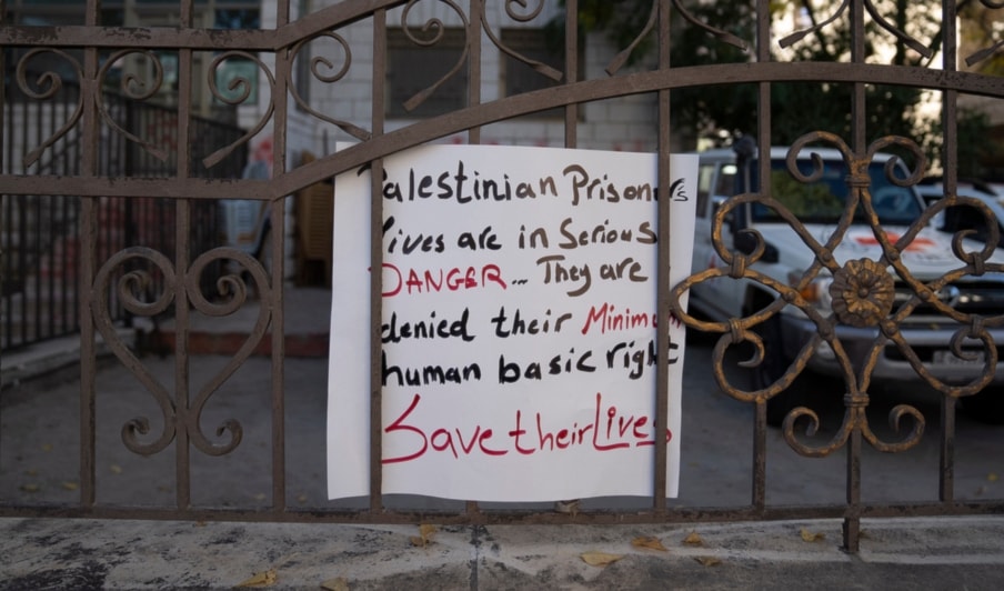 A placard is posted in front of the sealed International Committee of the Red Cross, ICRC office by angry Palestinian protesters, in the West Bank city of Ramallah, Thursday, Oct. 26, 2023. (AP)