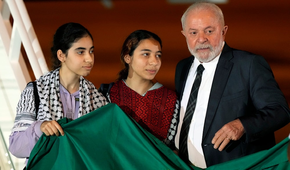 Brazil's President Luiz Inacio Lula da Silva talks to two young Brazilian women who were in the Gaza Strip, during their arrival at the Air Base, in Brasilia, Brazil, Monday, Nov. 13, 2023. (AP)