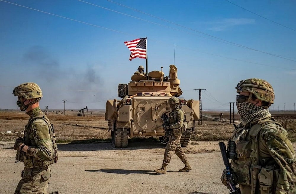 US soldiers walk while on patrol by the Suwaydiyah oil fields in Syria's northeastern Hasakah province on February 13, 2021. (AFP)