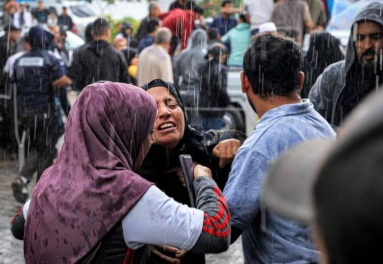 A Palestinian woman mourns for her family members killed by Israeli bombardment ahead of a mass funeral outside Nasser Hospital in Khan Younis. (AFP)
