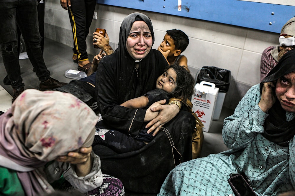 Wounded Palestinians sit in Shifa Hospital in Gaza City, central Gaza Strip, after arriving from al-Ahli Hospital following an explosion there, Tuesday, Oct. 17, 2023. (AP)