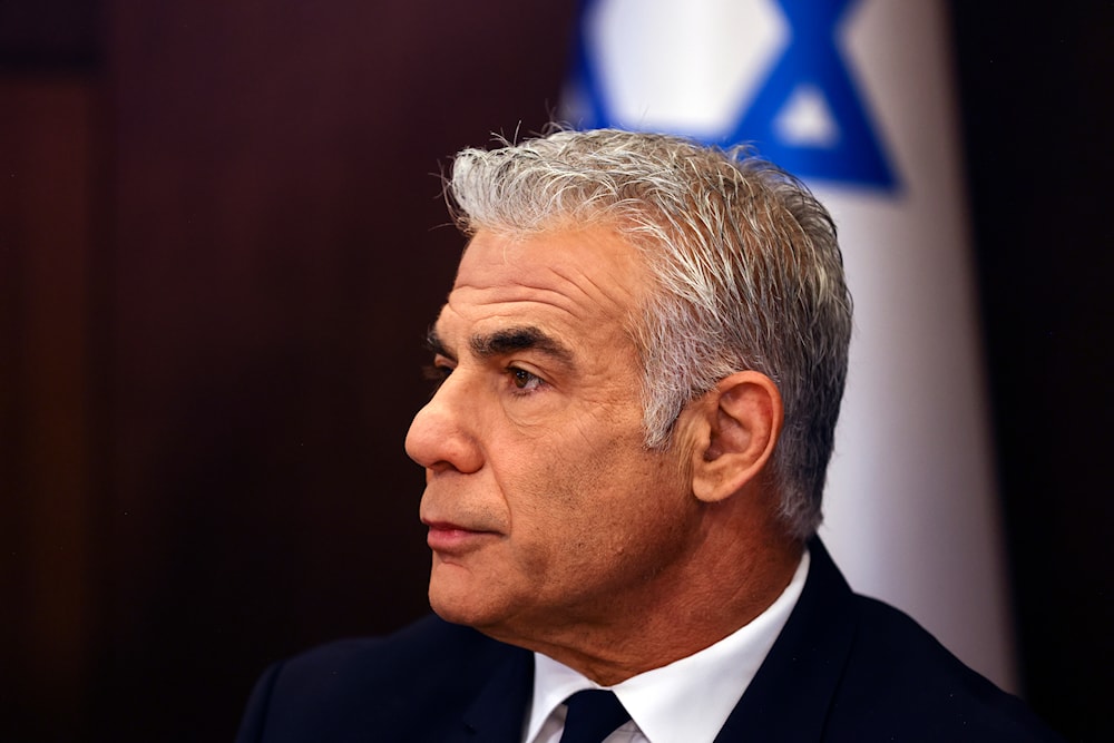 Israeli Prime Minister Yair Lapid chairs the weekly cabinet meeting, in occupied al-Quds, Sunday, Sept. 11, 2022. (AP)