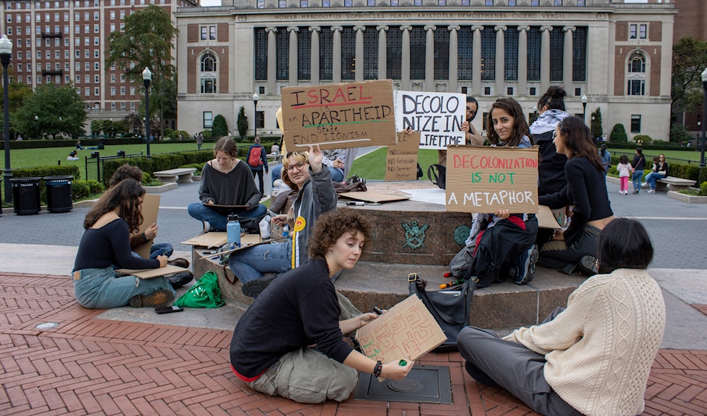 Demonstrators gather with signs near the Butler Library on the Columbia University campus in the Morningside Heights neighborhood of New York City on Sunday, October 8, 2023. (AP)