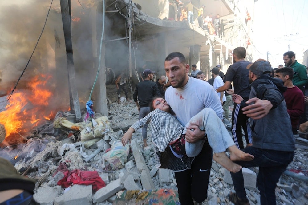 Palestinians rescue survivors after an Israeli strike on Rafah, Gaza Strip, Friday, Nov. 17, 2023. (AP Photo/Hatem Ali)