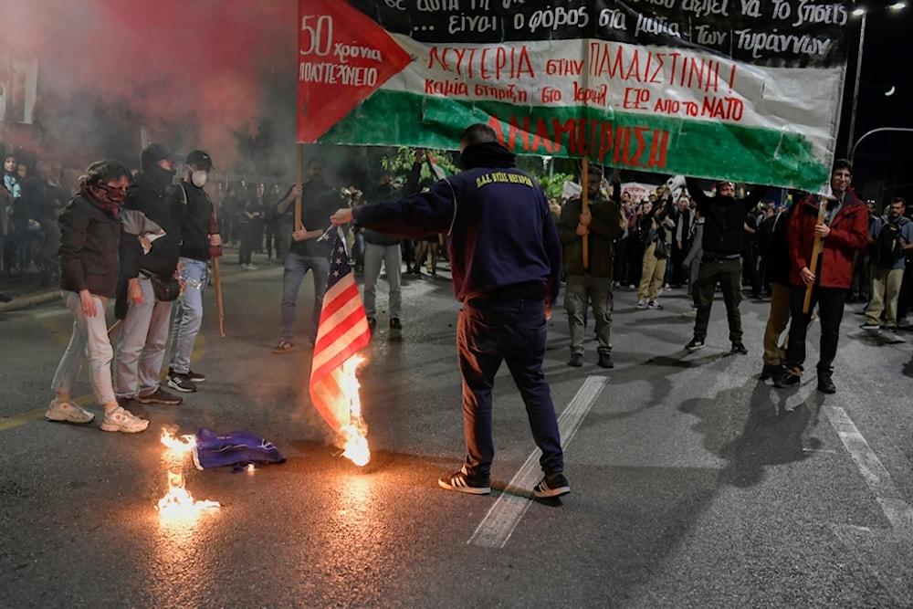 Pro- Palestinian protesters burn a U.S. flag out of the U.S. embassy in Athens, Friday, Nov. 17, 2023. (AP)