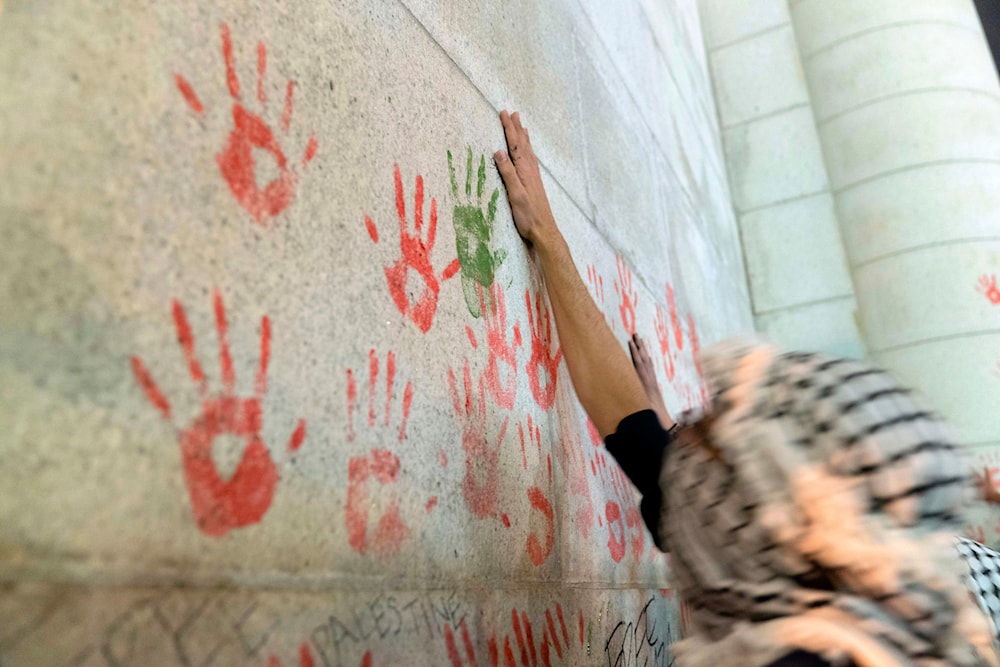 A protester make hand prints on the wall of Union Station building during a pro-Palestinian demonstration asking for a cease fire in Gaza in Washington, Friday, Nov. 17, 2023. (AP)