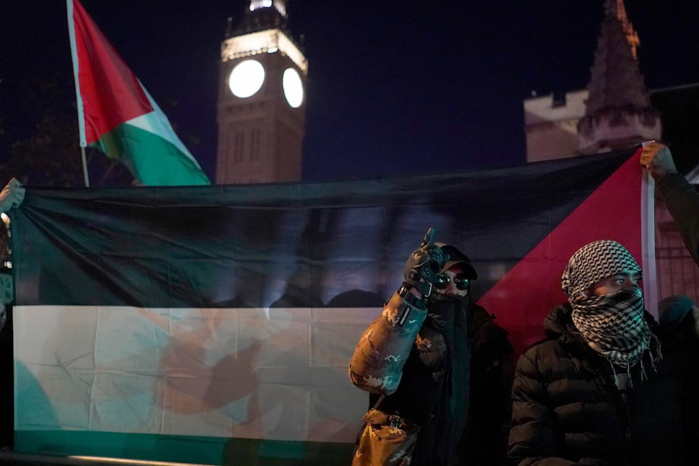 Protesters show flags during a pro-Palestinian protest in front of the Houses of Parliament in London, Wednesday, Nov. 15, 2023. (AP)