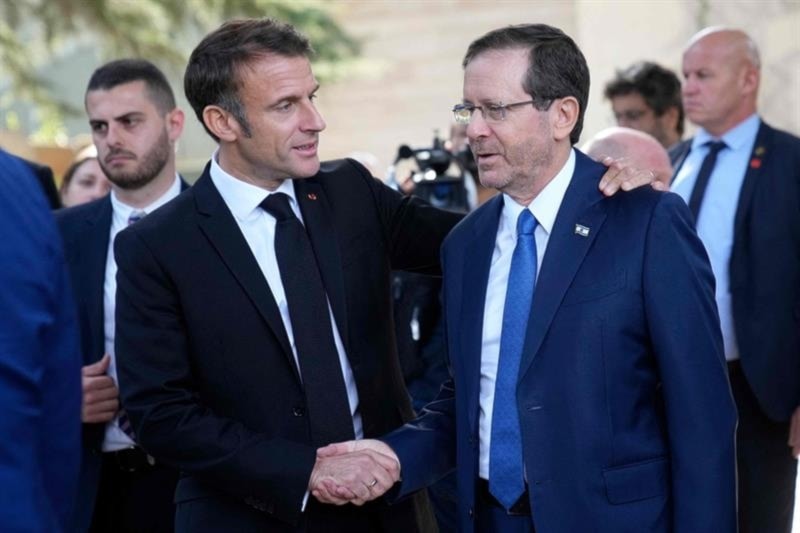 French President Emmanuel Macron shakes hands with Israeli President Isaac Herzog after their talks on October 24, 2023. (AFP)