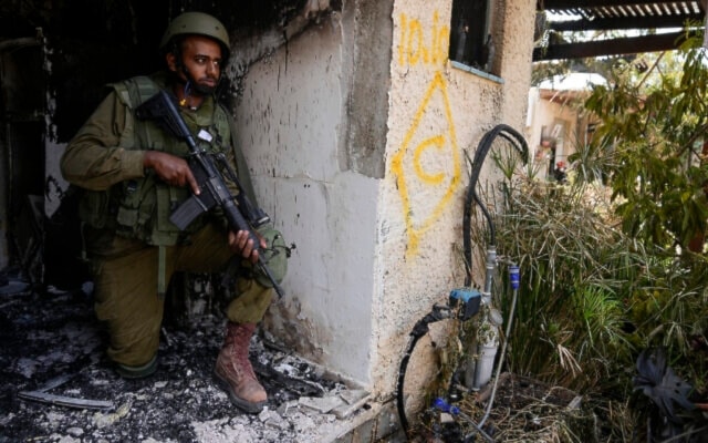An Israeli soldier takes a position in “Kibbutz Kfar Aza” on Tuesday, Oct. 10, 2023. (AP)