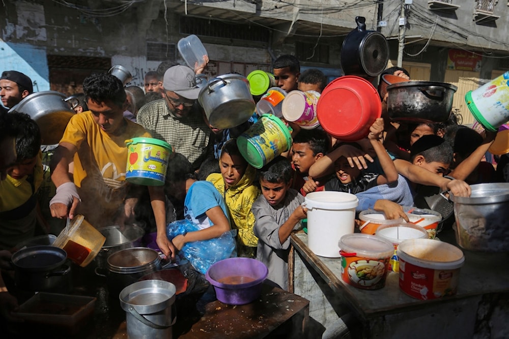 Palestinians crowded together as they wait for food distribution in Rafah, southern Gaza Strip, Wednesday, Nov. 8, 2023. (AP)