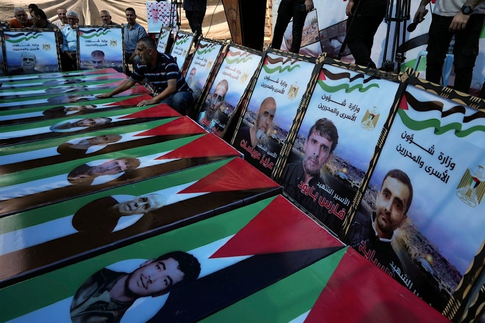 Palestinian demonstrators stand next to mock coffins symbolizing Palestinian prisoners killed in Israeli occupation prisons, during a protest, in Gaza City, occupied Palestine, Monday, Sept. 4, 2023. (AP)