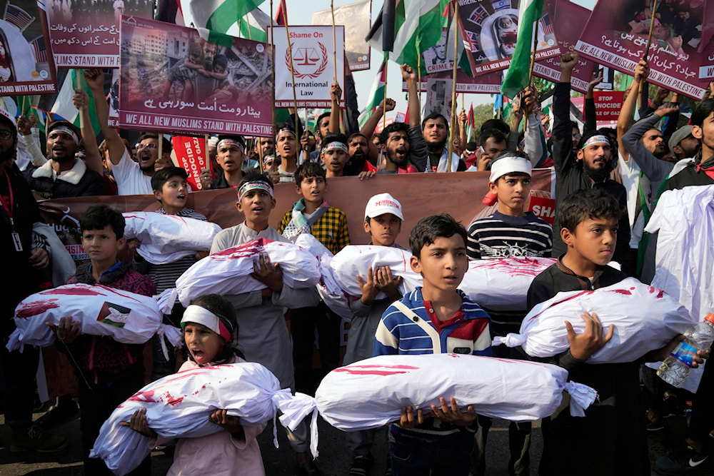 Children carry mock coffins as supporters from Pakistan’s main religious political party hold a rally in Pakistan on Nov. 19, 2023. (AP)