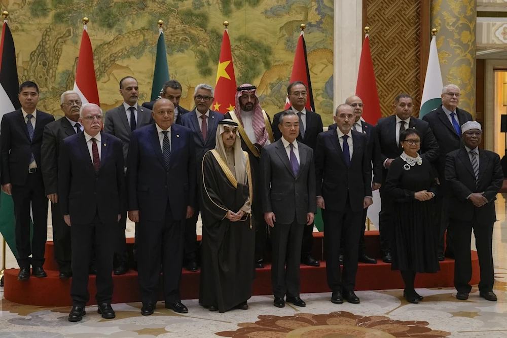 Gaza contact group diplomats pose with Chinese foreign minister Wang Yi prior to their meeting in Beijing on Monday 20 November, 2022 (AP)