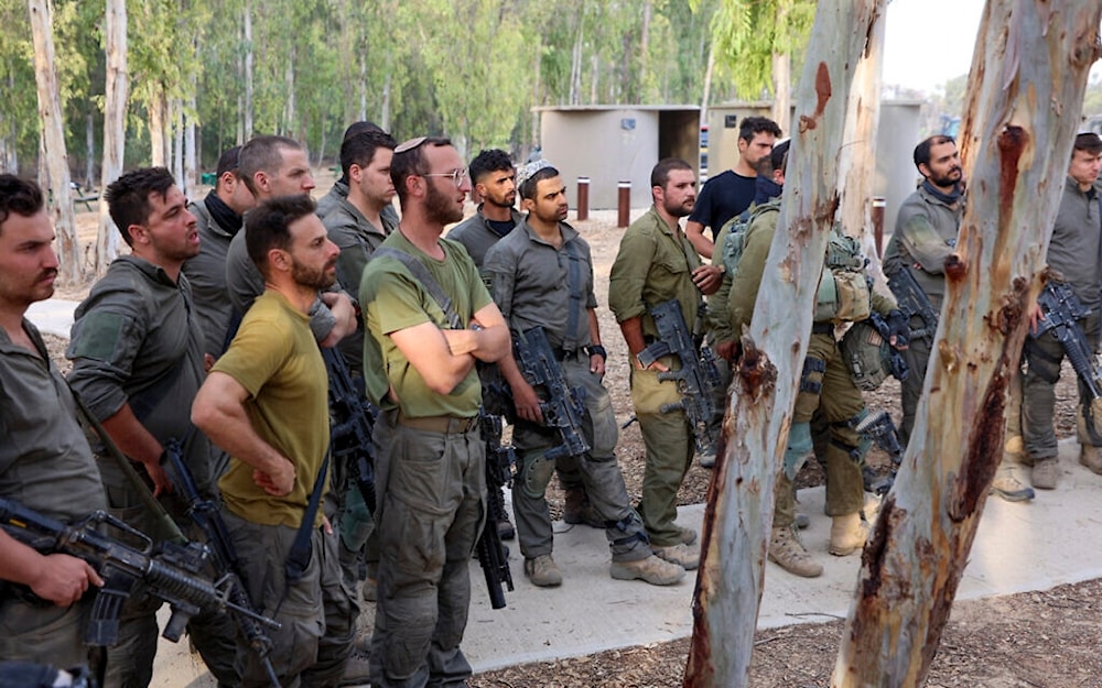 Israeli occupation soldiers gather before invading besieged Gaza on October 31, 2023. (AFP)