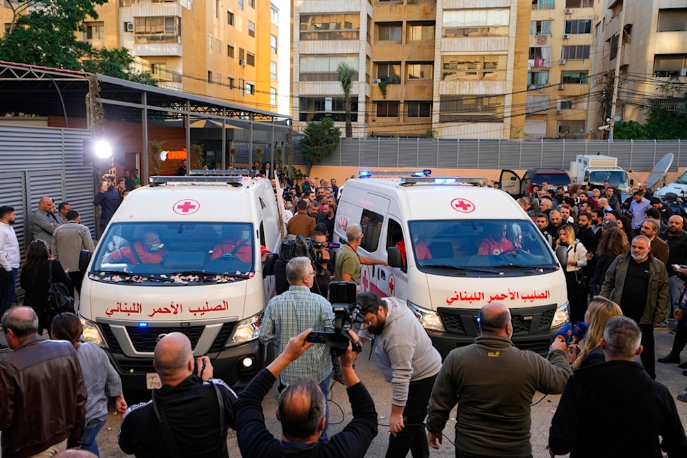 Journalists and family members gather next to Red Cross ambulances carrying the bodies of the two martyred Al Mayadeen journalists killed by an Israeli strike in southern Lebanon, at the station's headquarters in Beirut, Lebanon, Nov. 21, 2023