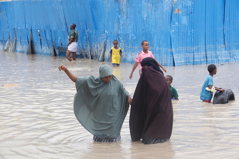 Somali women walk through floodwater during heavy rains in Mogadishu, Somali, Monday, Nov. 20, 2023. (AP)
