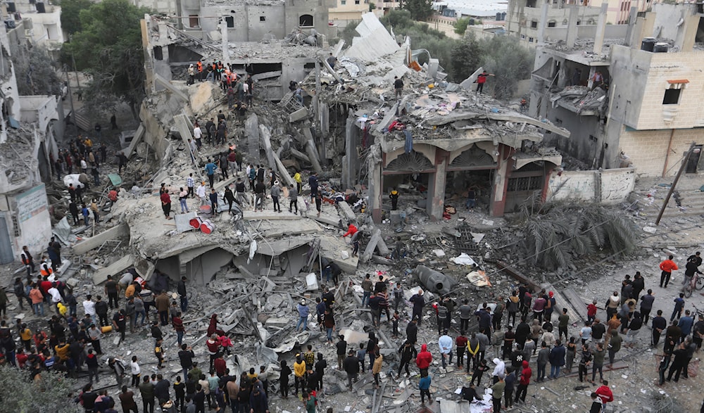 Palestinians search for survivors of the Israeli bombing in Rafah, Gaza Strip, Wednesday, Nov. 22, 2023. (AP)