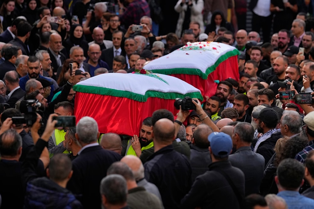 Mourners carry the coffins of the two journalists of pan-Arab TV network Al Mayadeen who were killed by an Israeli strike, at the station's headquarters, in Beirut, Lebanon, November 22, 2023 (AP)