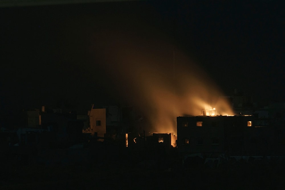 Flames engulf a building following an Israeli airstrike in Gaza, as seen from behind the Strip, Thursday, Nov. 23, 2023. (AP Photo/Leo Correa)