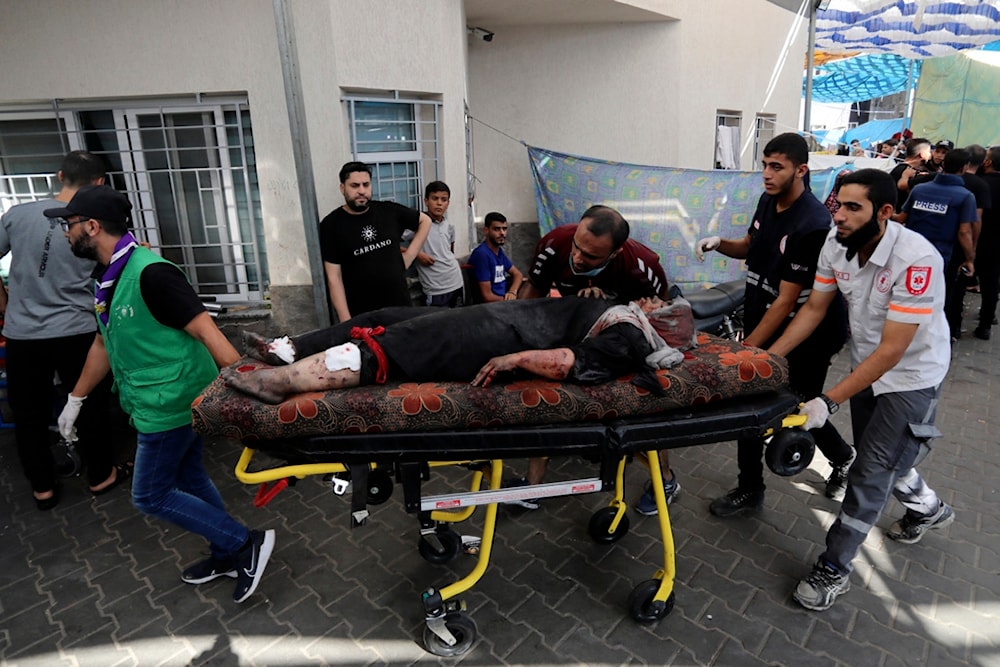 An injured Palestinian woman is wheeled into the al-Shifa hospital, following Israeli airstrikes on Gaza City, occupied Palestine, Sunday, Nov. 5, 2023. (AP)