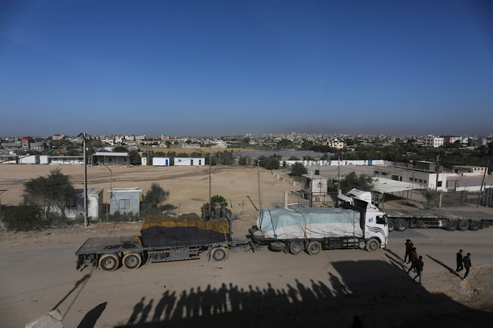 Trucks carrying humanitarian aid enter Gaza Strip from Egypt in Rafah as a temporary ceasefire went into effect Friday, Nov. 24, 2023 (AP Photo/Hatem Ali)