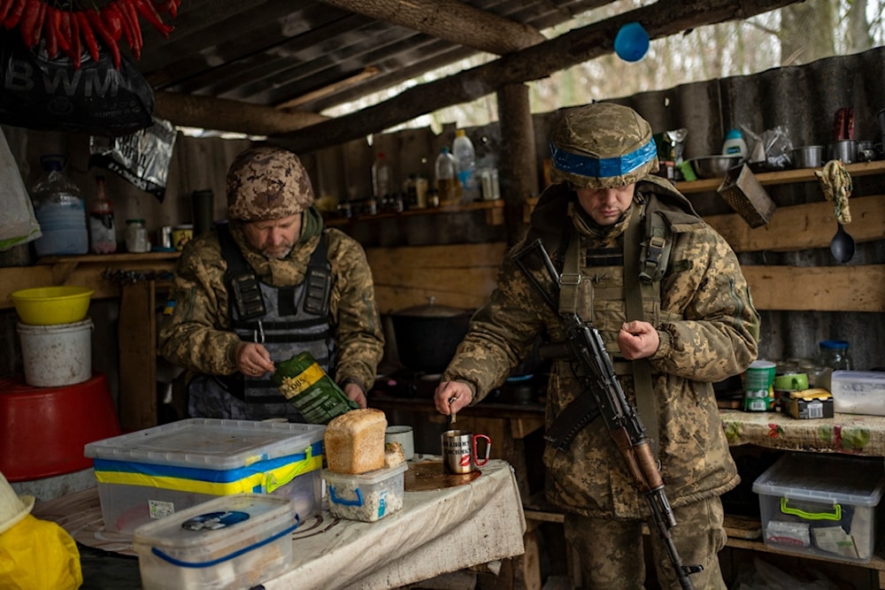 Soldiers of Ukraine's state border guard have a break for tea at a military position in Sumy region, Ukraine, Friday, Nov. 24, 2023 (AP Photo/Hanna Arhirova)