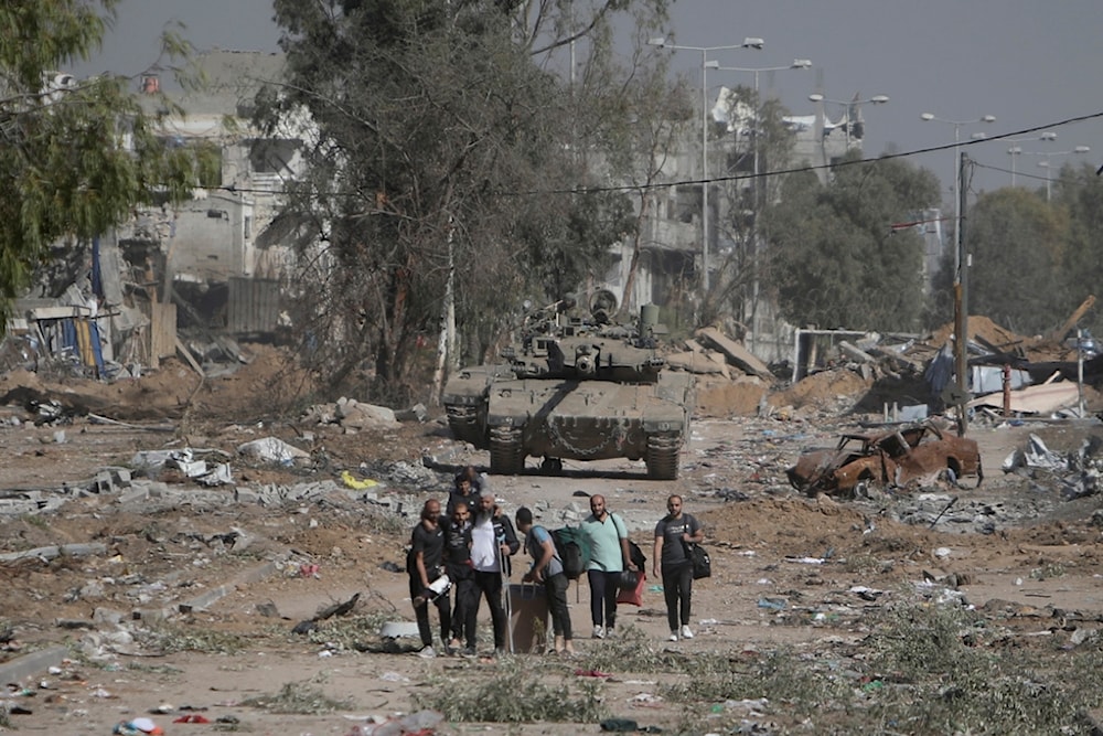 Palestinians flee to northern Gaza as Israeli tanks block the Salah al-Din road in the central Gaza Strip, occupied Palestine, November 24, 2023 (AP)