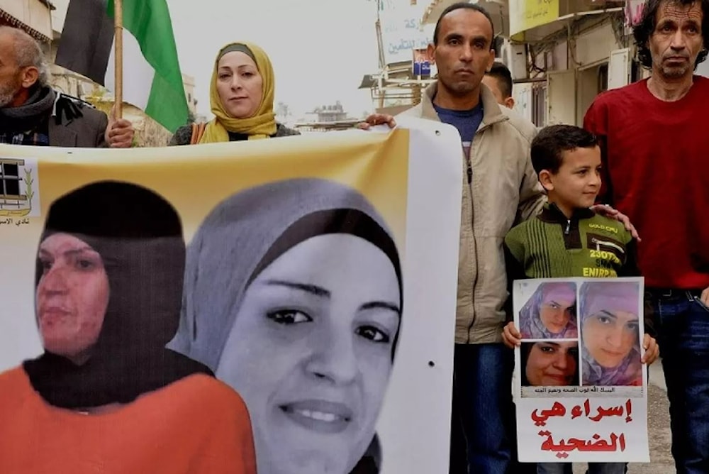 The son of Palestinian detainee Israa Jaabees who has been detained since 2015 and denied medical care on several occasions, participates in a protest for her release in 2018. (Muna Jaabis/Facebook)