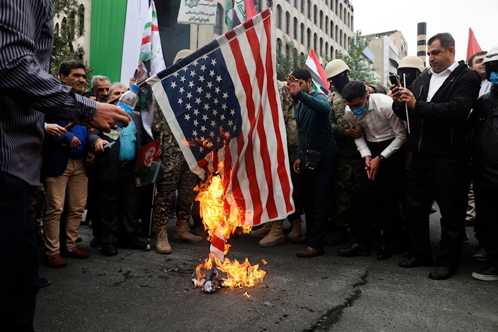 Iranian worshippers burn a U.S. flag during their pro-Palestinian rally before the Friday prayers in Tehran, Iran, Friday, Oct. 13, 2023. (AP Photo)