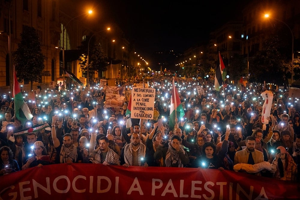 Demonstrators use the flashlights on their mobile phones as they protest against Israeli attacks on Gaza, in Barcelona, Spain on Nov. 11, 2023. (AP Photo/Emilio Morenatti, File)