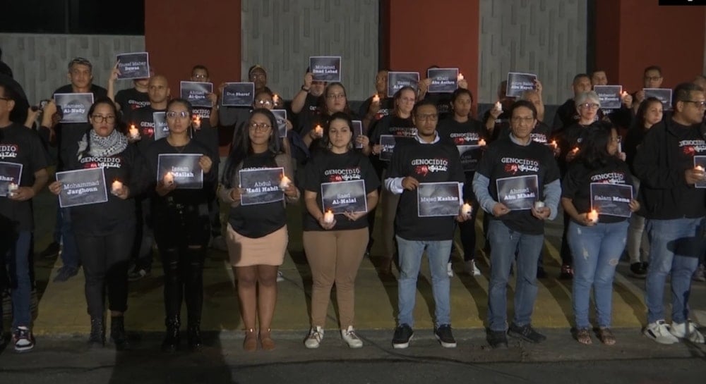 A group of journalists and activists held a vigil in front of Telesur network's building in Caracas in solidarity with Al Mayadeen's martyrs Farah Omar, Rabih Me'mari, and Hussein Akil. (Telesur)