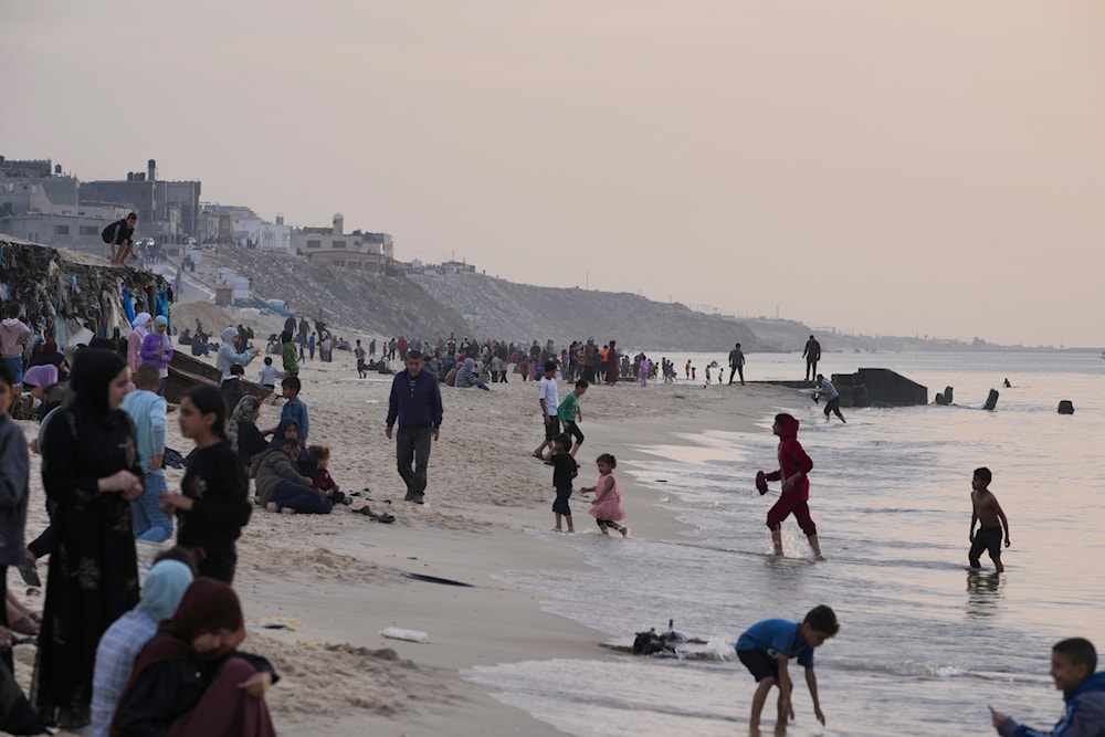 Palestinians visit the beach in Deir al Balah, Gaza Strip, on the second day of a cease-fire in the Gaza Strip, Saturday, Nov. 25, 2023. (AP)