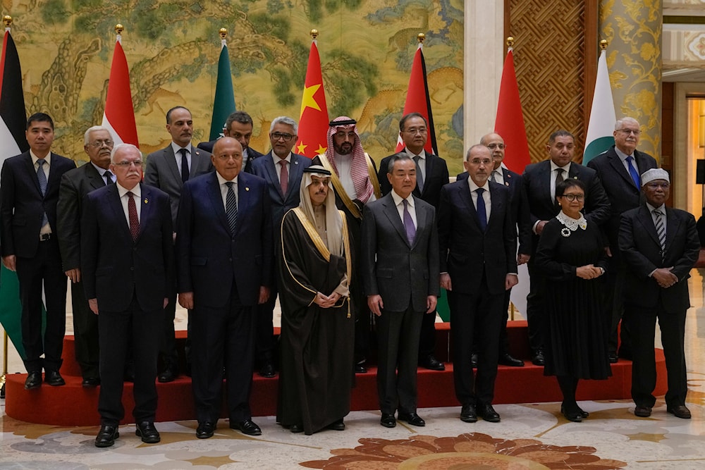 Chinese Foreign Ministry spokesperson Wang Yi with diplomats from the Gaza contact group in Beijing on November 20, 2023 (AP)