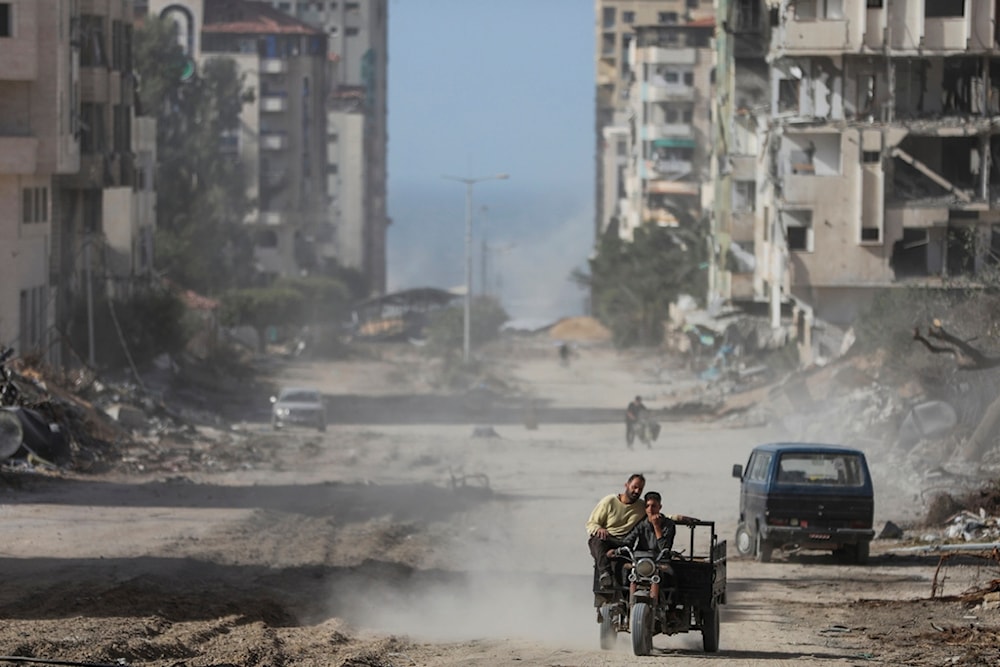 Palestinians drive through Gaza City on Sunday, Nov. 26, 2023 (AP Photo/Mohammed Hajjar)