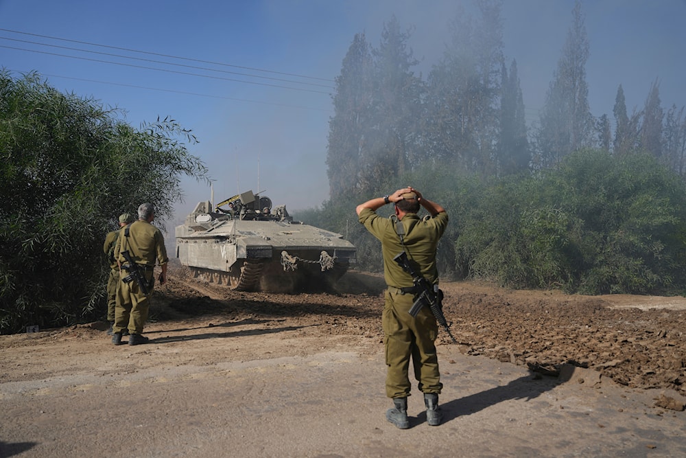 A convoy of Israeli army vehicles maneuvers near border after leaving Gaza, southern Israel, on Friday, Nov. 24, 2023. (AP)