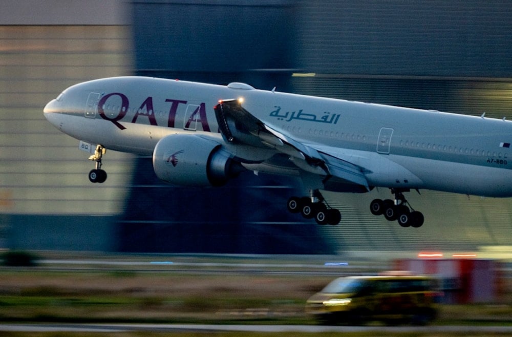 A Qatar airways plane lands at the airport in Frankfurt, Germany, as the sun rises on Monday, Sept. 25, 2023 (AP Photo/Michael Probst)